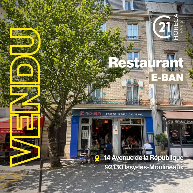 Exterior of E-BAN Korean restaurant on a sunny Paris street, with large vertical yellow branding on the left and address visible at bottom.